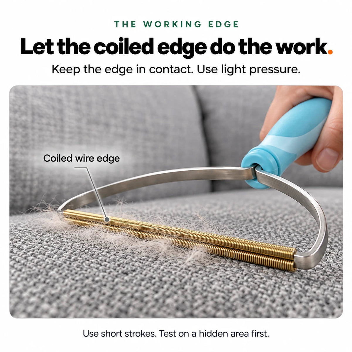The coiled wire edge of the handheld scraper pulling pet hair out of a sofa