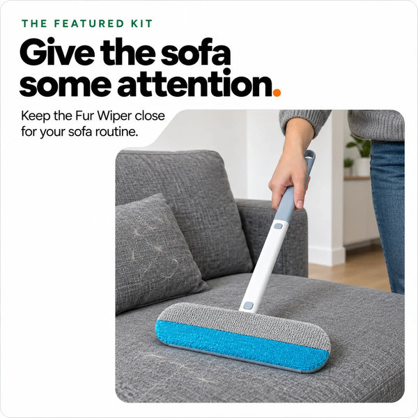 Brushing cat hair off a grey sofa cushion with the Fur Wiper from the kit