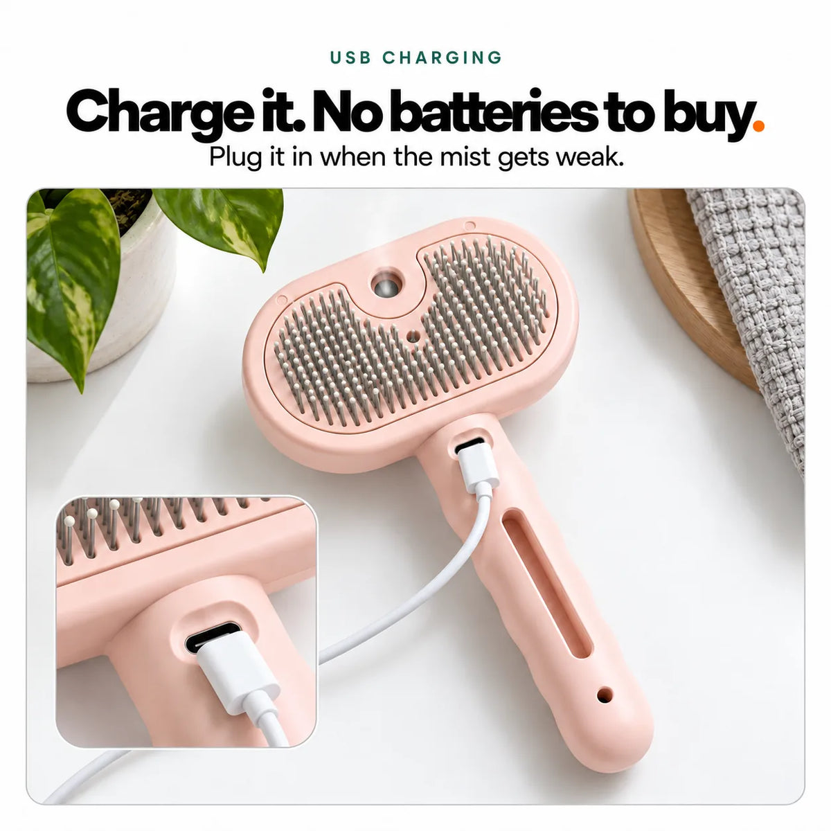 The pink Mist Comb charging by USB-C, with the socket just below the brush head